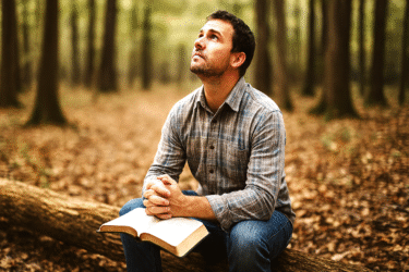 Man Praying in Woods